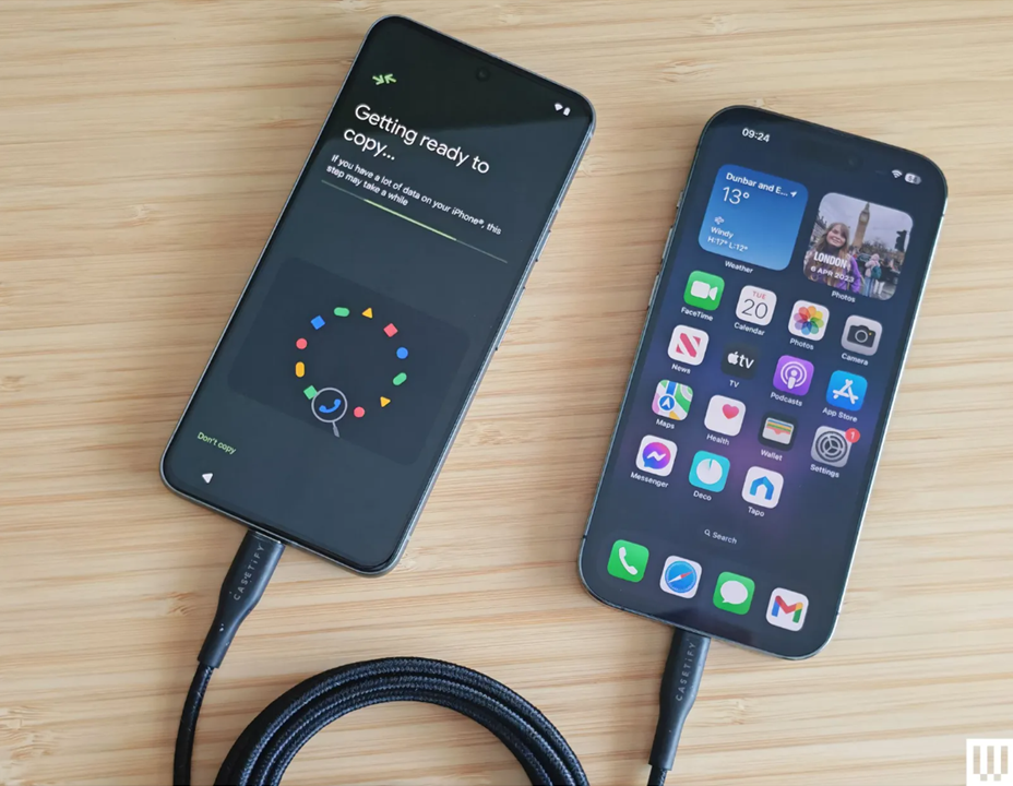 an iphone and android phone tethered by a cable.