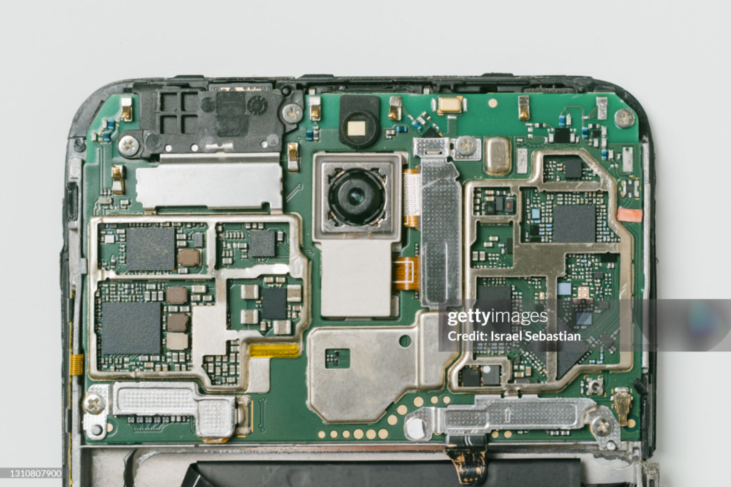 This detailed view of a mobile circuit board emphasizes the complexity of "controlling the full stack," showing how proprietary chips must integrate seamlessly with other internal hardware.